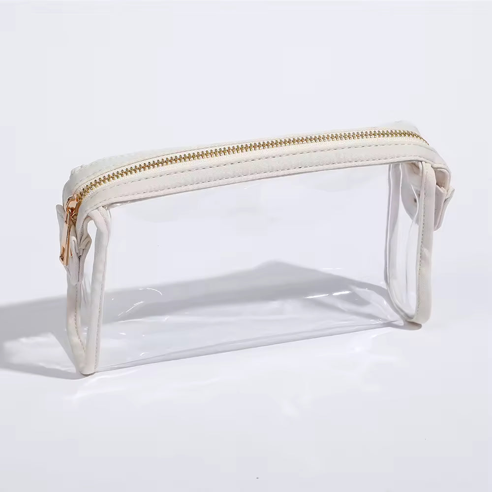 Clear pouch cosmetic bag with gold zipper on a white background CarrieAway
